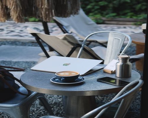 A modern cafe table in Mexico City with a laptop and a cup of coffee