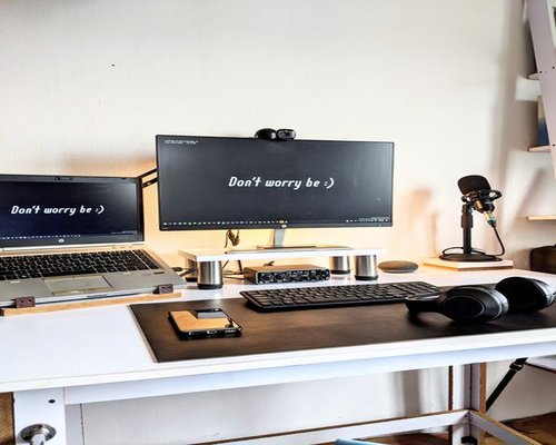 A clean, organized desk setup with a laptop positioned at eye level