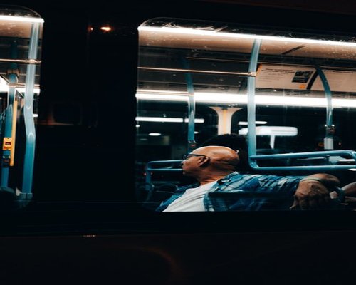 Person resting by looking out the window of a bus in Mexico