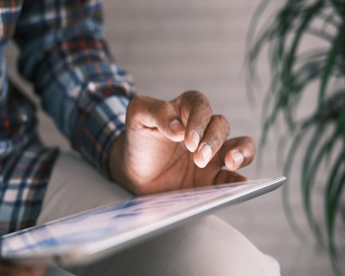 Hands adjusting the brightness settings on a tablet device
